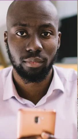 Portrait of a young man holding a phone
